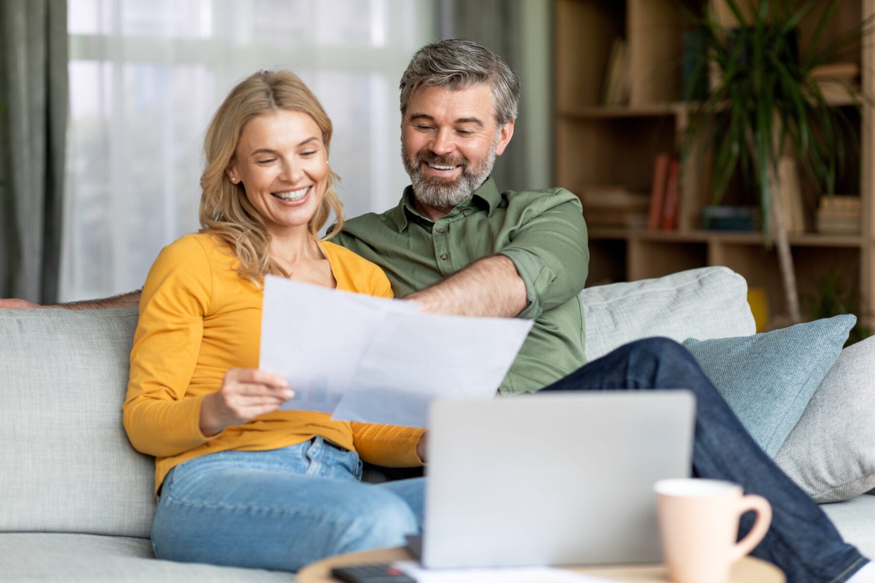 Family Insurance Concept. Happy Middle Aged Couple Reading Documents