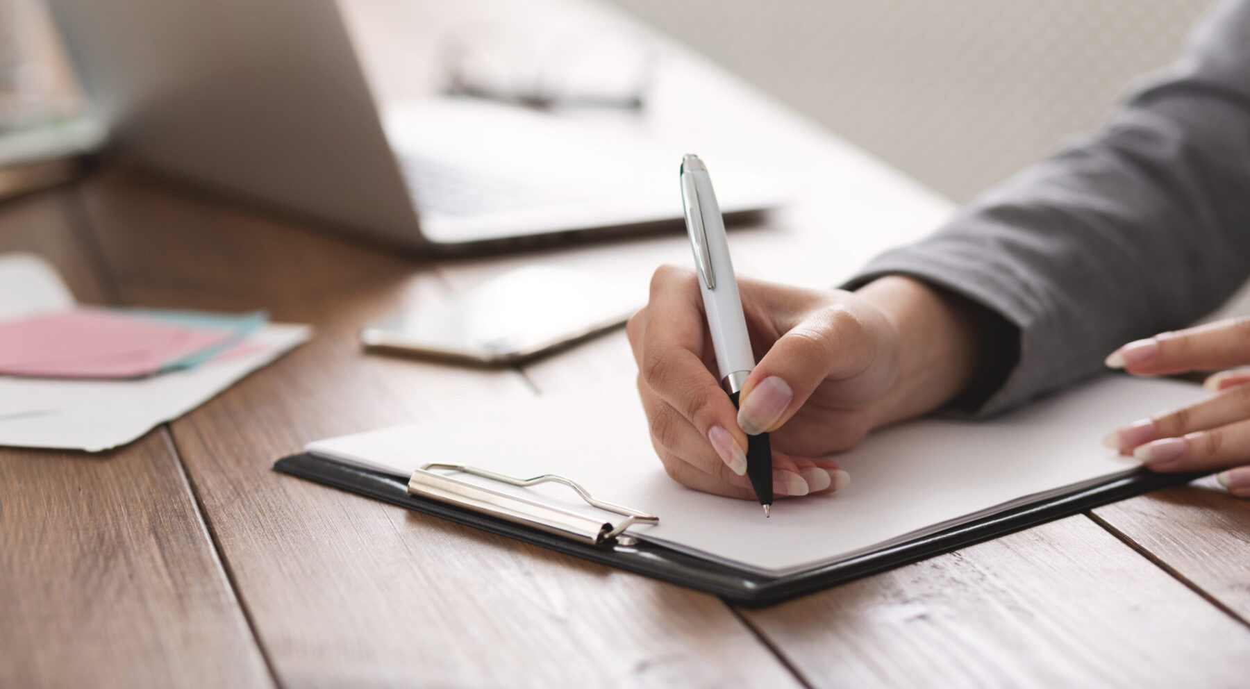 Woman writing on paper.