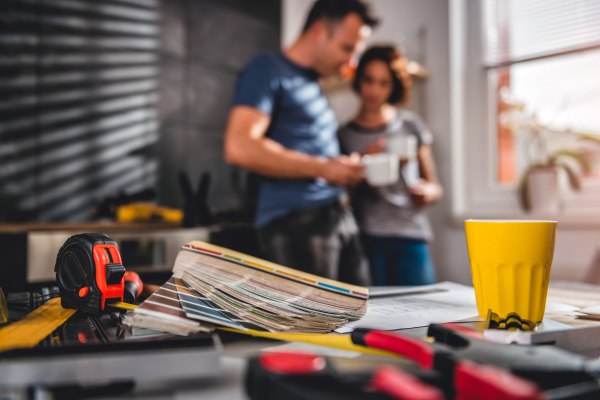 Couple taking in background. Tools and paint swatches.