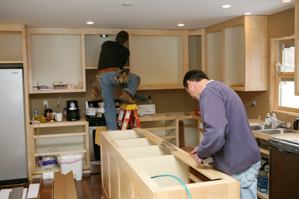 Two men working on kitchen remodel.